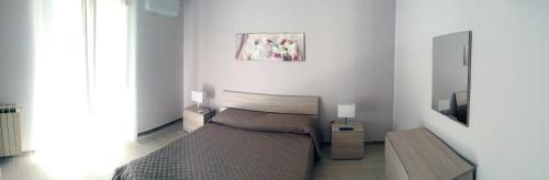 En eller flere senge i et værelse på Brevi vacanze a Brolo
