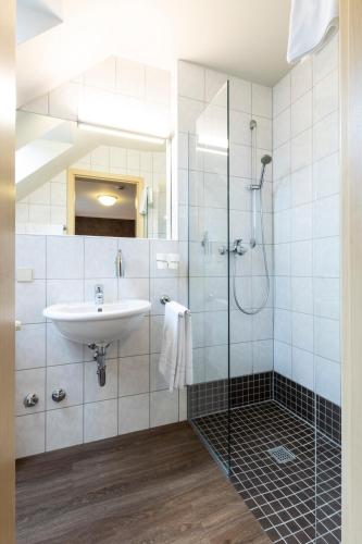 a bathroom with a sink and a shower at Stadthotel in Kaiserslautern
