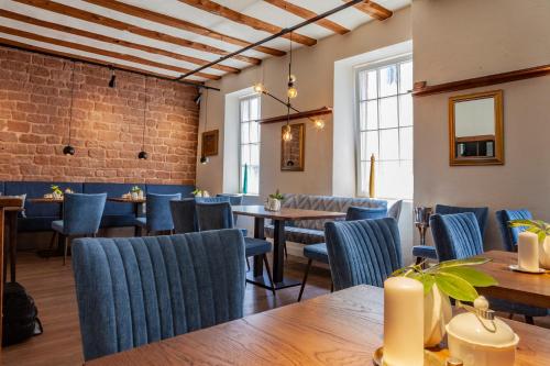 a dining room with blue chairs and tables at Stadthotel in Kaiserslautern