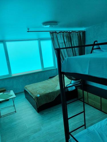 a room with a bed and a table in it at Silver 2 Затока in Zatoka