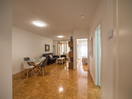 a living room with a couch and a table at Gestión de Alojamientos Apartments in Pamplona