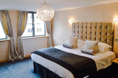a hotel room with a large bed and a large window at Posh Pads - Liverpool 1 - Apart-Hotel in Liverpool