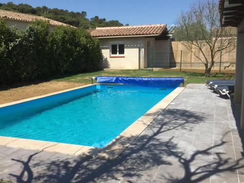 a swimming pool with a blue tarp around it at Résidence Alpha Centauri in Carcassonne