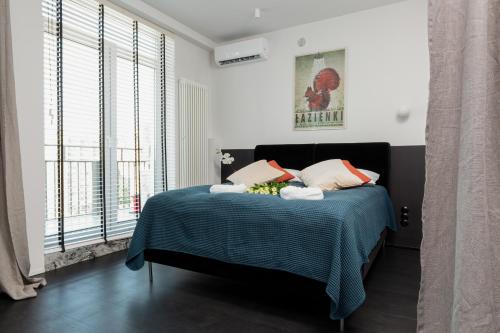 a bedroom with a bed with a blue blanket at Marszałkowska 140 Apartments in the Center of Warsaw by Renters in Warsaw