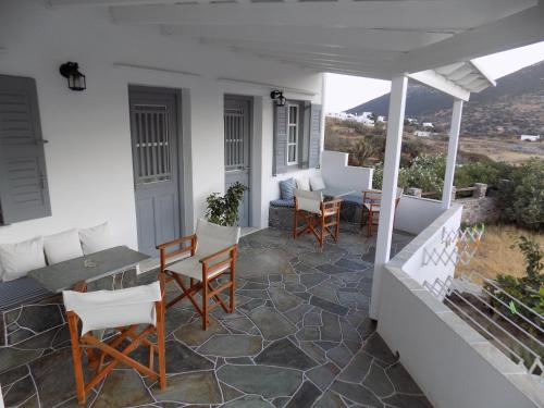 a patio with chairs and a table on a house at Margarita Karidi in Apollonia