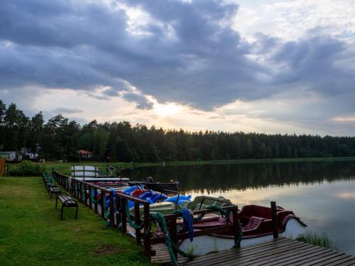 a row of boats parked next to a lake at Załakowo Na Gwizdówce 13 całoroczny domek na Kaszubach in Załakowo