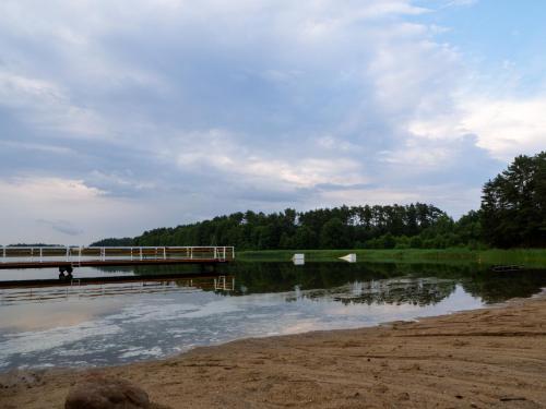a bridge over a body of water with trees at Załakowo Na Gwizdówce 13 całoroczny domek na Kaszubach in Załakowo