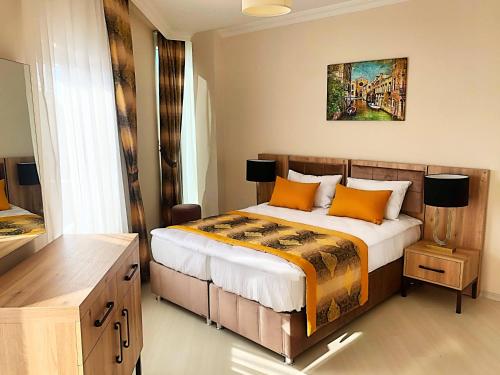 Ένα ή περισσότερα κρεβάτια σε δωμάτιο στο Alfa Apart Hotel