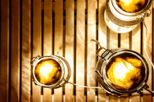 two mason jars of food cooking in an oven at Casa Duci in Agrigento