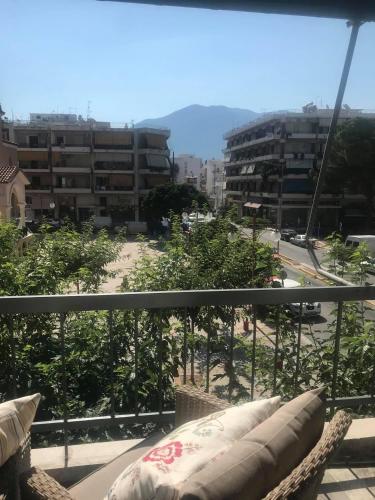 a balcony with a view of a city at Pepromeno LUXURY APARTMENT IN THE CITY CENTER in Kalamata