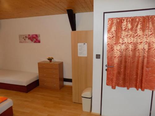 a small bedroom with a bed and a door at Ubytování Apartmány Ferenčíková in Nové Hrady