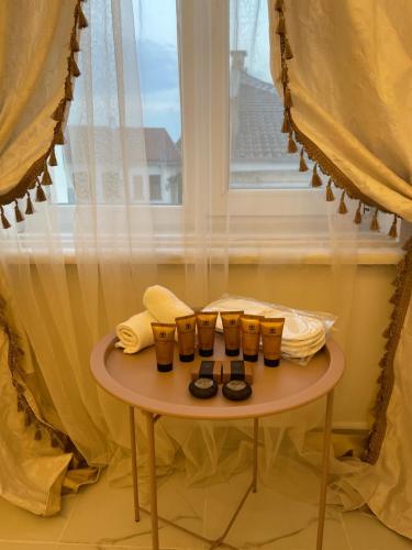 a table with a group of glasses on it next to a window at Villa al Tempio in Pazardzhik