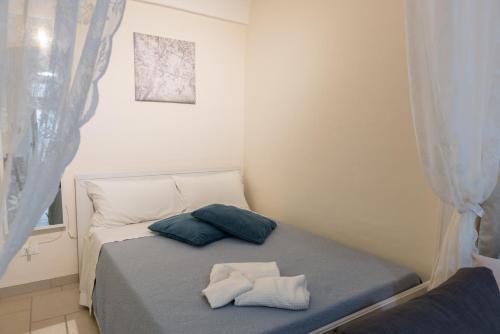 a small bedroom with a bed with two pillows on it at Casa Galliani Ostuni in Ostuni