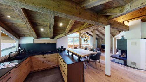 a kitchen with wooden ceilings and a wooden table at A Casa Kristall in Sölden