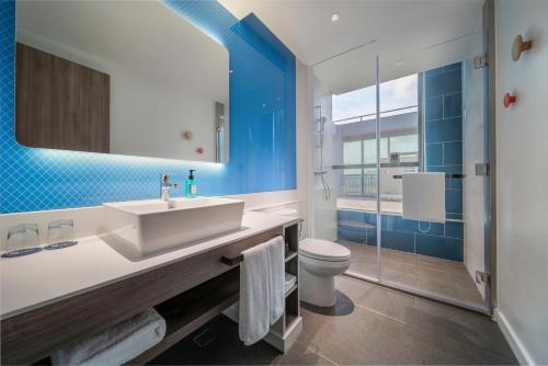 a bathroom with a sink and a toilet at Holiday Inn Express Zhuhai Gongbei by IHG in Zhuhai