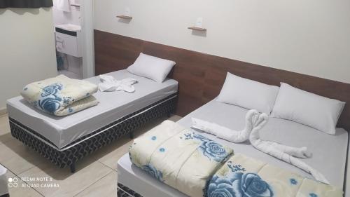 Katil atau katil-katil dalam bilik di Pousada Quarto completo ar,wi fi e garagem gratuita