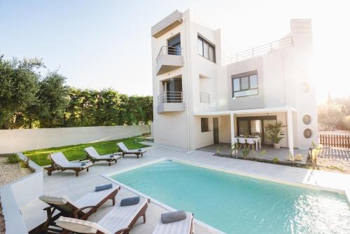 a villa with a swimming pool and a house at Anssami Villa in Rhodes Town