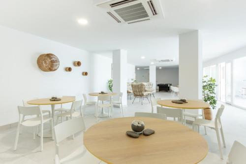 a group of tables and chairs in a room at Apartamentos Martalia Nerja in Torrox