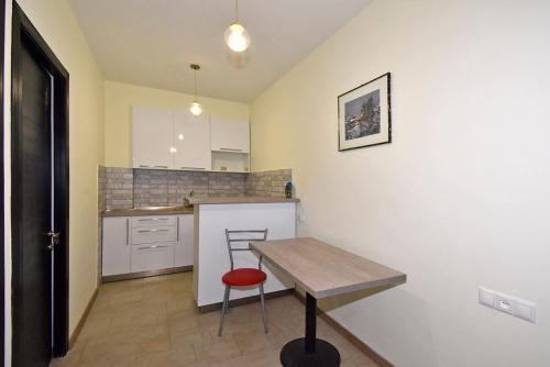 a small kitchen with a wooden table and a counter at The Nut Guest House in Yerevan