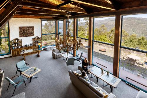 a room with couches and chairs and windows at Pousada Geres-Caniçada in Geres