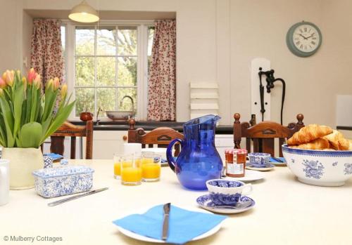 a table with a blue pitcher and a bowl of food at Bressingham Hall in Bressingham