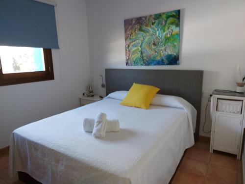 a bedroom with a bed with towels on it at Villa en Sa Caleta - CAN BLAU IBIZA in Ibiza Town