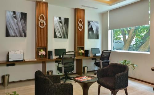 a waiting room with chairs and a table at Welcomhotel by ITC Hotels, Richmond Road, Bengaluru in Bangalore