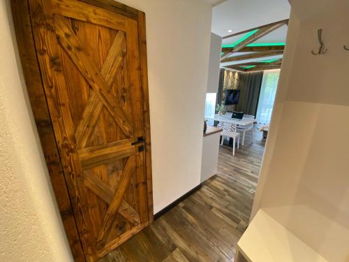 a wooden door in a hallway with a dining room at Matrix in Tatranská Lomnica