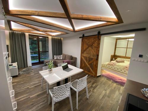a room with a table and chairs and a bed at Matrix in Tatranská Lomnica
