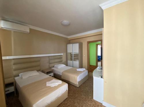 Posteľ alebo postele v izbe v ubytovaní Hotel Genatsvale