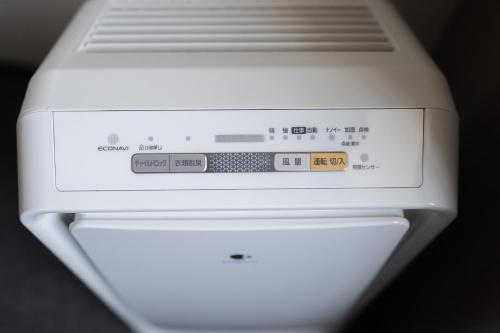 a close up of a white microwave oven at Route Inn Grantia Tokai Spa&Relaxation in Tokai