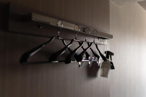 a rack of utensils hanging from a wall at Route Inn Grantia Tokai Spa&Relaxation in Tokai