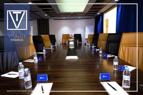 a conference room with a long table with bottles of water at Hotel Vitality Terminus in Kenitra