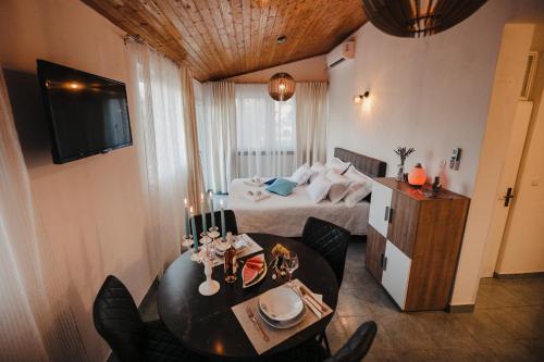 a hotel room with a bed and a table and chairs at Studio apartmant Tonka in Šibenik