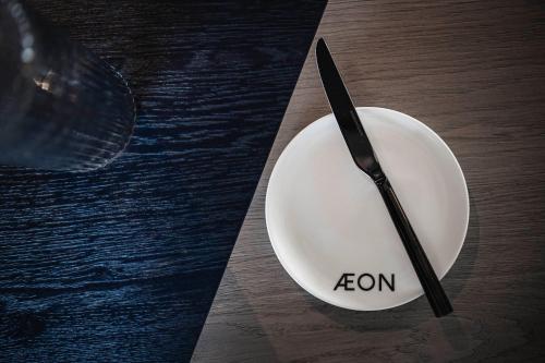 a knife sitting on a plate on a table at AEON Hotel - adults only Bed & Breakfast in Soprabolzano