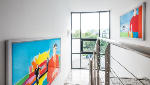 a hallway with a large painting on the wall at Art Hotel City Leipzig in Leipzig