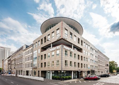 a large building with a dome on top of it at Art Hotel City Leipzig in Leipzig