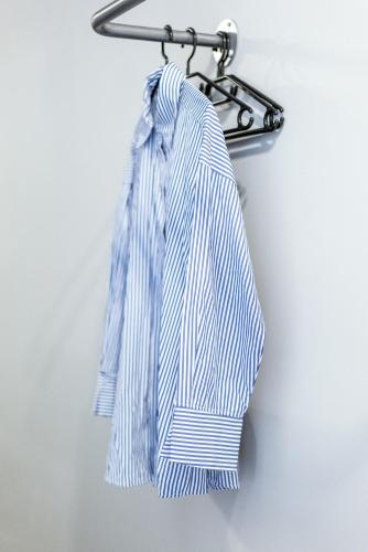 a blue and white tie hanging on a hanger at Unique Experience Apartment’s in Thessaloniki