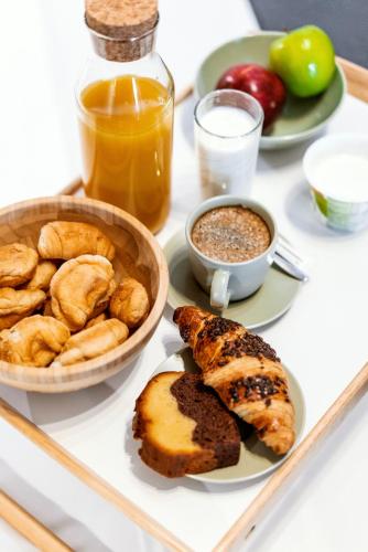 a tray of food with bread and other foods on it at Unique Experience Apartment’s in Thessaloniki