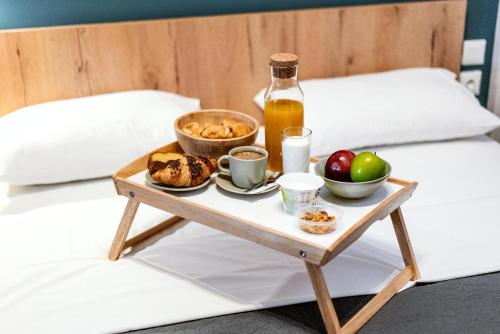 a tray of breakfast food on a bed at Unique Experience Apartment’s in Thessaloniki