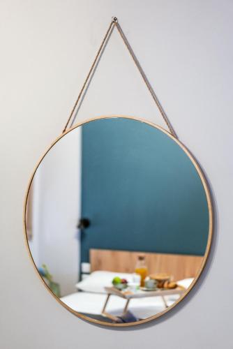a mirror hanging on a wall in a room at Unique Experience Apartment’s in Thessaloniki