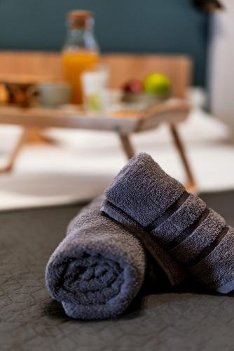 a towel laying on the floor in front of a table at Unique Experience Apartment’s in Thessaloniki