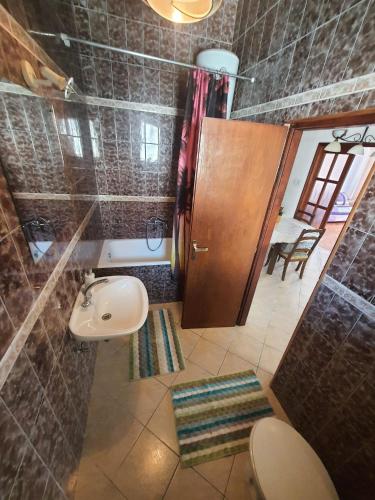 a small bathroom with a toilet and a sink at Apartment 2 in Podstrana