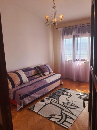 a bedroom with a bed and a rug on the floor at Apartment 2 in Podstrana