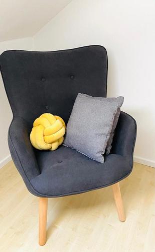a banana sitting on a blue chair with a pillow at Ferienwohnung im Romantikhof in Breitenbrunn