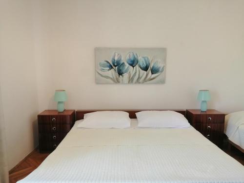 sypialnia z dwoma łóżkami i obrazem na ścianie w obiekcie Apartment Vera, 80 m from the sea w mieście Novigrad
