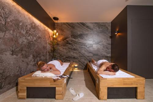 two people sleeping in beds in a room at Lubhotel in Lublin
