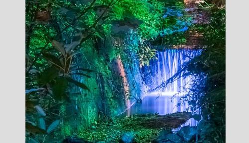 a painting of a waterfall in a forest at Little Gem with Private Hot Tub - Up to 25 percent off ferry in Shanklin