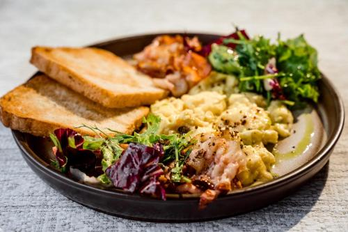a plate of food with bread and salad and toast at Turiyske Podvir'ya in Blazhennik