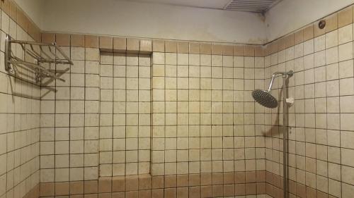 a shower in a tiled bathroom with at Sangam Hotel Muzaffarabad in Muzaffarabad
